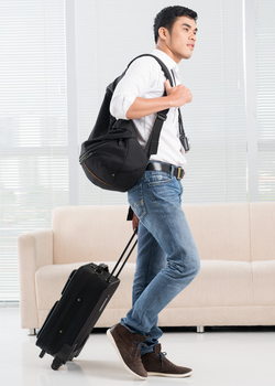 young man with carry on bags