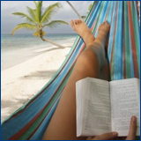 woman in hammock reading book, palm tree