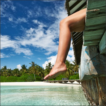 legs dangling over dock