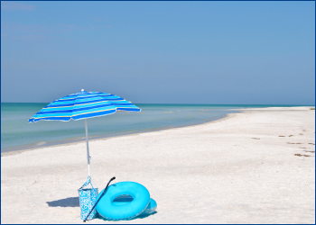 umbrella, bag and swim ring on beach