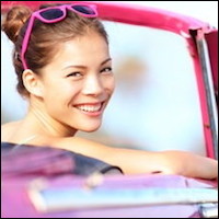 Young woman in hot pink car