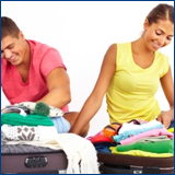young couple packing for vacation