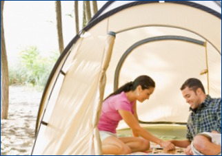 couple playing board game in tent