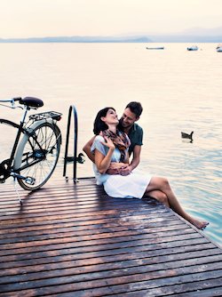 couple on dock with bike