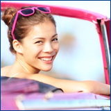 smiling woman pink car