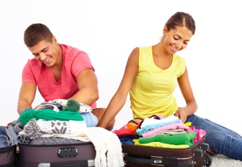Young man and woman packing for vacation